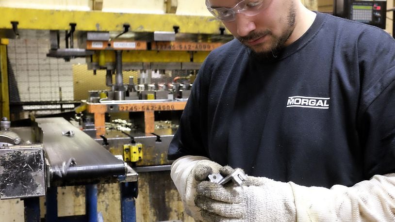 A Morgal employee checks one of the metal parts the company was manufacturing for Honda at the McGregor Metalworking facility on South Yellow Springs Street. Bill Lackey/Staff