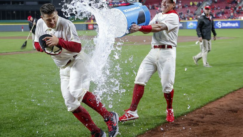 CINCINNATI, OH - MAY 04: Nick Senzel #15 of the Cincinnati Reds gets a celebratory soaking from Derek Dietrich #22 of the Cincinnati Reds following the game against the San Francisco Giants in which Senzel scored his first career home run at Great American Ball Park on May 4, 2019 in Cincinnati, Ohio. (Photo by Michael Hickey/Getty Images)