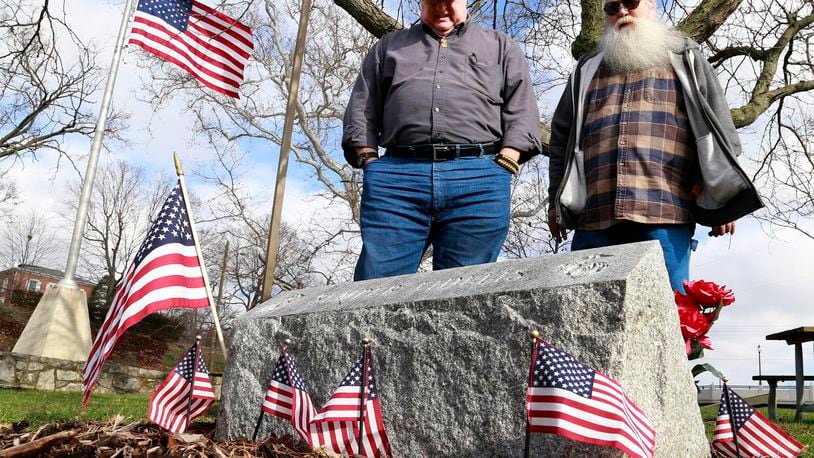 Randy Ark, left, and Roger Warren look over the Marine Corp memorial that Warren and his Maine Corp. brothers dedicated in 1988 at Veteran’s Park. Bill Lackey/Staff