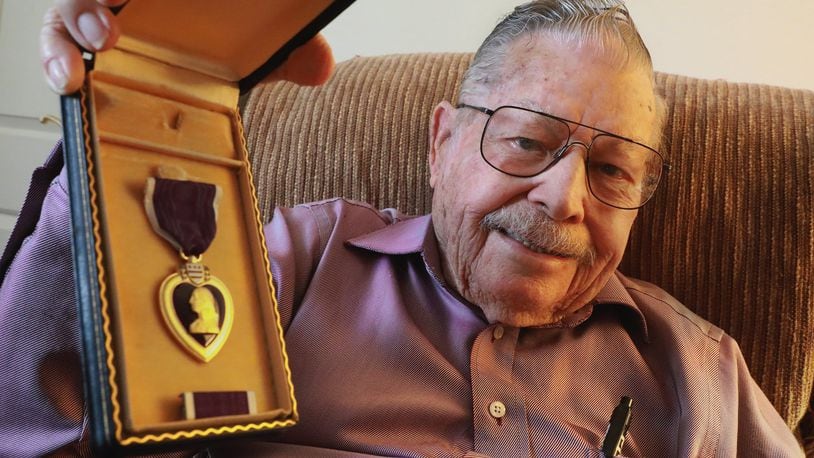 D-Day veteran Albert Carr is very proud of the Purple Heart medal he received during WWII. Carr was shot twice during he service in the war. BILL LACKEY/STAFF