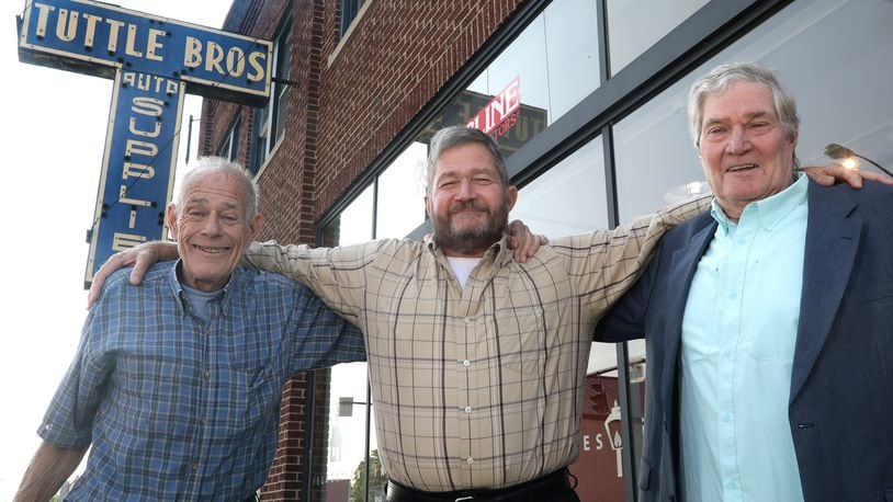 The Tuttle brothers, from left, Rob, Curt and Tom in front of the Tuttle Bros. Building in downtown Springfield. BILL LACKEY/STAFF