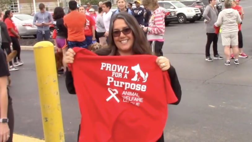 The Springfield High National Honor Society will host the Prowl for a Purpose 5K run/walk on May 7 to benefit mental health services for children at Oesterlen. Here, NHS Advisor Niki Sage holding up a shirt at a previous year's 5K. Contributed