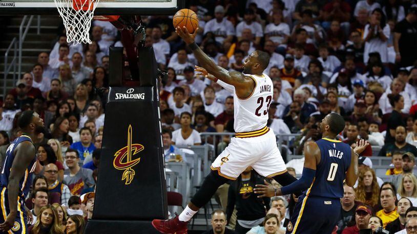 CLEVELAND, OH - APRIL 15: LeBron James #23 of the Cleveland Cavaliers gets to the basket past CJ Miles #0 of the Indiana Pacers during the first half in Game One of the Eastern Conference Quarterfinals during the 2017 NBA Playoffs at Quicken Loans Arena on April 15, 2017 in Cleveland, Ohio. NOTE TO USER: User expressly acknowledges and agrees that, by downloading and or using this photograph, User is consenting to the terms and conditions of the Getty Images License Agreement.  (Photo by Gregory Shamus/Getty Images)