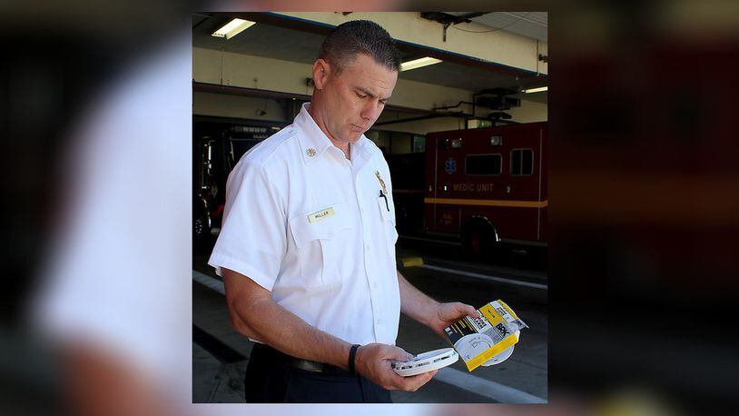 Springfield’s new Fire Chief Brian Miller holds one of the new, 10-year-battery-life smoke detectors the station wants to install for free in senior citizens homes. JEFF GUERINI/STAFF