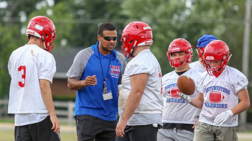 Northwestern High School football coach Shane Carter talks to his offensive line during a practice on Thursday in Springfield. Fall sports practice began across Ohio on Thursday. CONTRIBUTED PHOTO