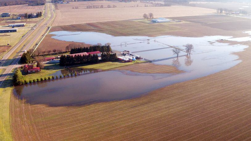 This farm along Ohio 42 in Spring Valley was surrounded by flood waters after a several days of rain. TY GREENLEES / STAFF