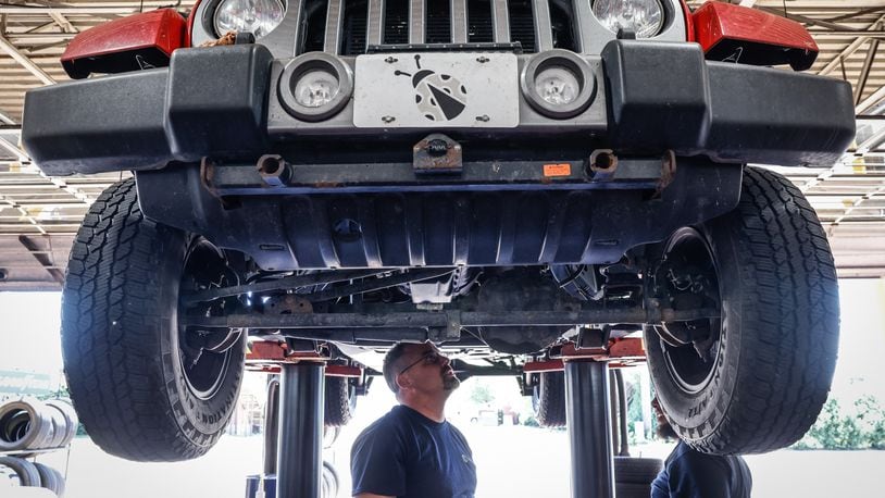 Jamie's Tire & Service manager, Rob Leach, left, and Technician  James Wellman work on Jeep Friday afternoon June 24, 2022. The business will participate in Wednesday's summer job fair at Wright State University's Nutter Center. JIM NOELKER/STAFF