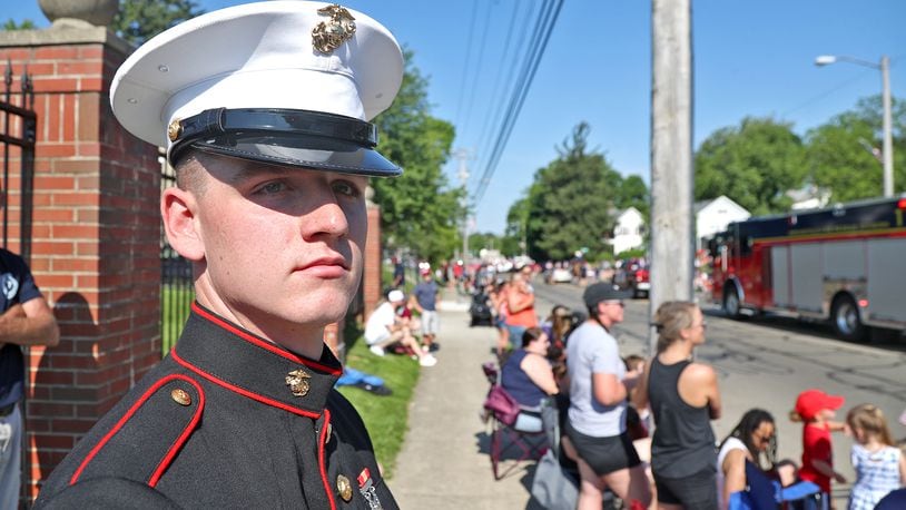 Marine Corp. Pvt. Nicholas Johnson watches the Springfield Memorial Day Parade in his dress uniform Monday, May 30, 2022. Thousands of people lined the parade route to watch the annual event. BILL LACKEY/STAFF