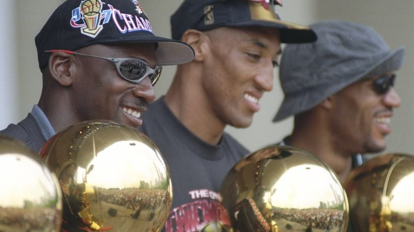 16 Jun 1997: Guard Michael Jordan, forward Scottie Pippen and forward Dennis Rodman of the Chicago Bulls look at their trophies during the Chicago Bulls Victory Parade in Chicago, Illinois. The BUlls defeated the Utah Jazz in 6 games to win the 1998 NBA Championship Finals.