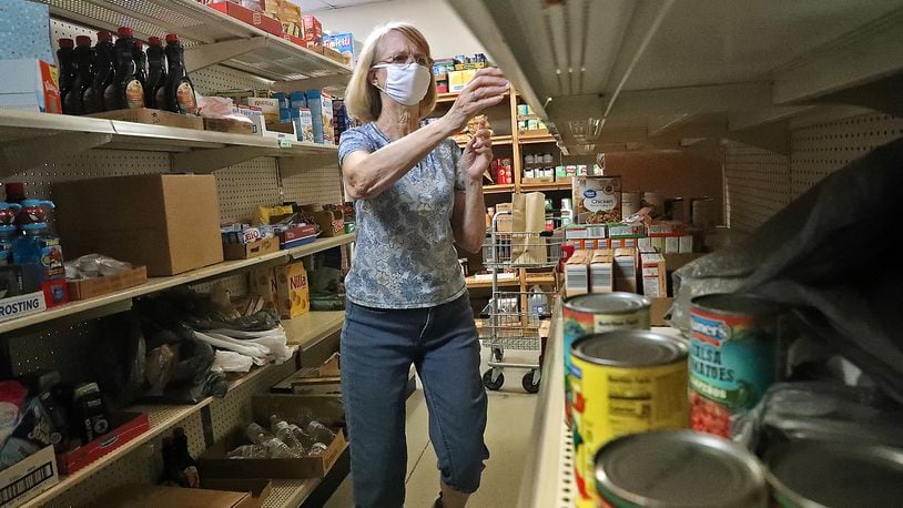 Volunteer Sherry Bostick collects items from the Enon Emergency Relief pantry for people in need in this 2020 file photo. BILL LACKEY/STAFF