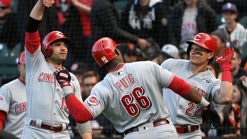 SAN FRANCISCO, CALIFORNIA - MAY 11: Yasiel Puig #66 of the Cincinnati Reds celebrates his two-run home run against the San Francisco Giants with Derek Dietrich #22 and Joey Votto #19 in the first inning of their MLB game at Oracle Park on May 11, 2019 in San Francisco, California. (Photo by Robert Reiners/Getty Images)