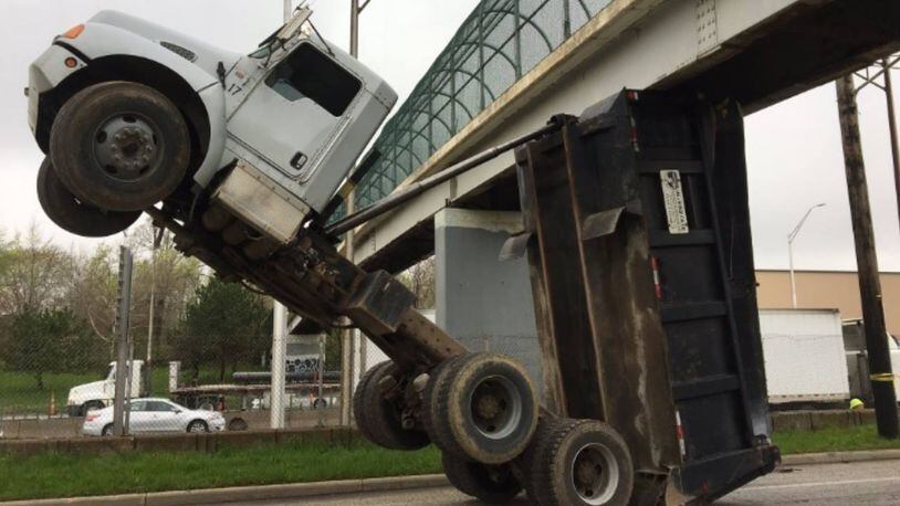 A garbage truck was wedged into a pedestrian bridge early Tuesday on a Cleveland interstate.
