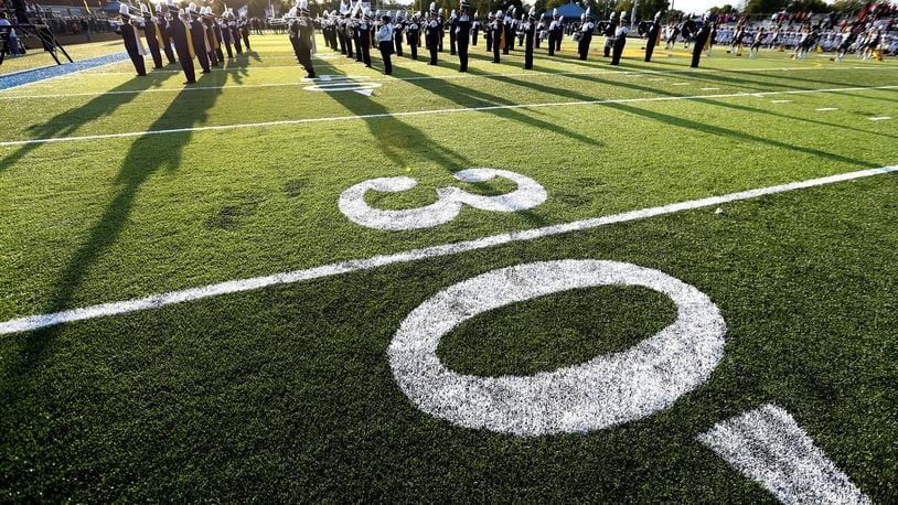 The Springfield High School Marching Band play the National Anthem on the new artificial turf that has been installed at Evans Stadium Friday before the start of the Wildcats’ football game against Lima Senior. Bill Lackey/Staff