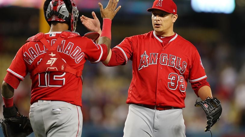 LOS ANGELES, CA - JUNE 26:  Martin Maldonado #12 of the Los Angeles Angels and David Hernandez #33 of the Los Angeles Angels celebrate their 4-0 win against the Los Angeles Dodgers at Dodger Stadium on June 26, 2017 in Los Angeles, California.  (Photo by Joe Scarnici/Getty Images)