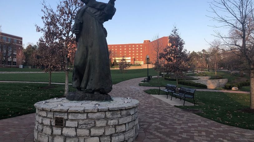 Wednesday was a sunny 75-degree April day at the University of Dayton, but the statue of Marianist founder William Chaminade oversaw a nearly empty campus. Residence halls, like the Marycrest Complex in the background, are almost empty due to coronavirus-related closures. JEREMY P. KELLEY / STAFF
