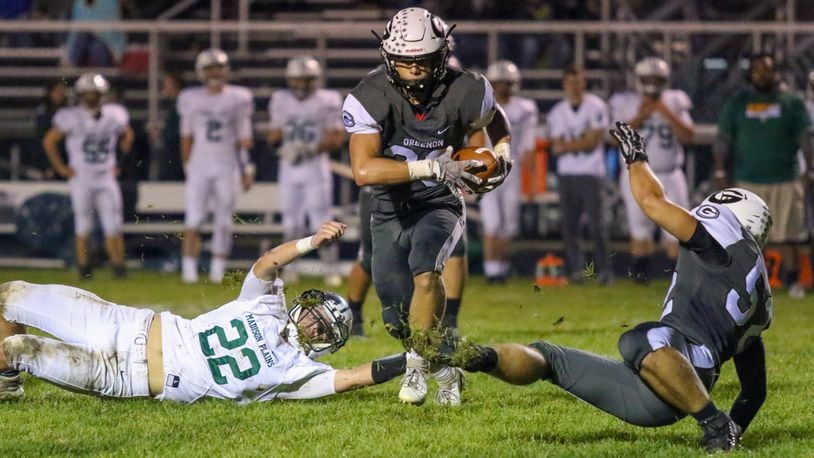 Greenon High School's Kameron Cox runs past a Madison Plains defender during their game last season. Cox was a D-V All-Ohio Honorable Mention selection last fall. CONTRIBUTED PHOTO BY MICHAEL COOPER