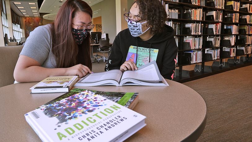 Clark State College students Gracie Perkins, left, and Jasmin Alford study about addiction Thursday in the Clark State Library. BILL LACKEY/STAFF