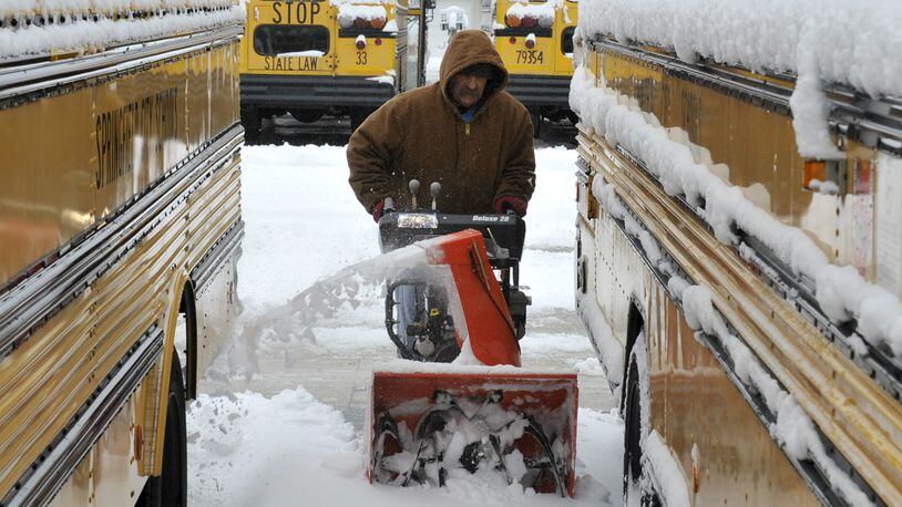 In this 2013 file photo: Tom Jenkins, a bus driver for Springfield City Schools, uses a snow blower to clear a path between the school district's buses Wednesday, March 6, 2013. Most schools in the area were closed Wednesday after several inches of snow fell across the area overnight. Bill Lackey/Staff