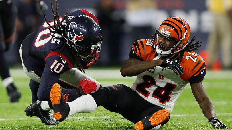 HOUSTON, TX - DECEMBER 24: Adam Jones #24 of the Cincinnati Bengals tackles DeAndre Hopkins #10 of the Houston Texans in the fourth quarter at NRG Stadium on December 24, 2016 in Houston, Texas. (Photo by Tim Warner/Getty Images)
