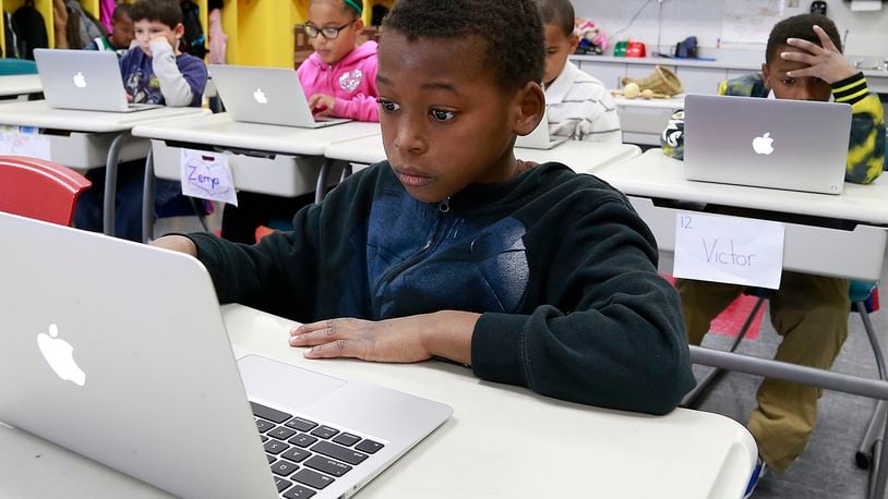 Anthony Marshall and his third grade classmates work on their labtop computers in class Friday. Bill Lackey/Staff