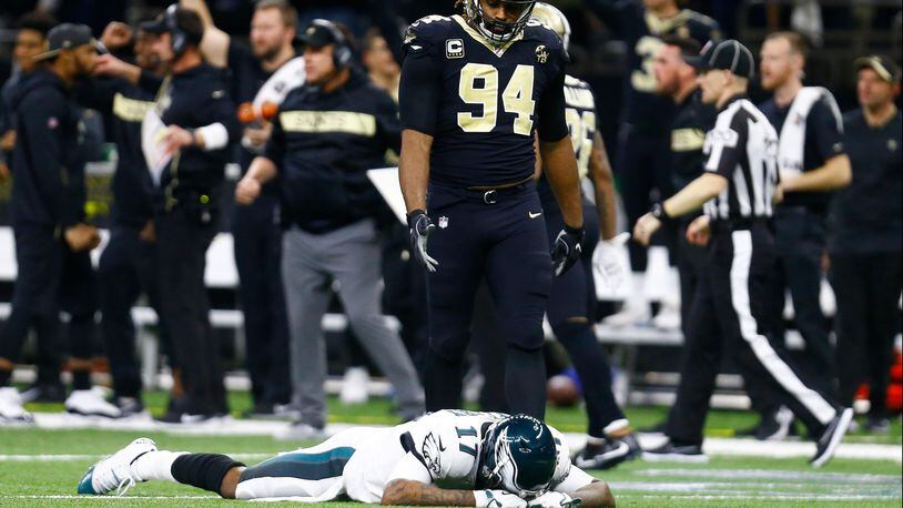 Philadelphia Eagles wide receiver Alshon Jeffery (17) lies on the turf in front of New Orleans Saints defensive end Cameron Jordan (94) after the Saints intercepted a pass in the fourth quarter of  Sunday's NFL divisional game.