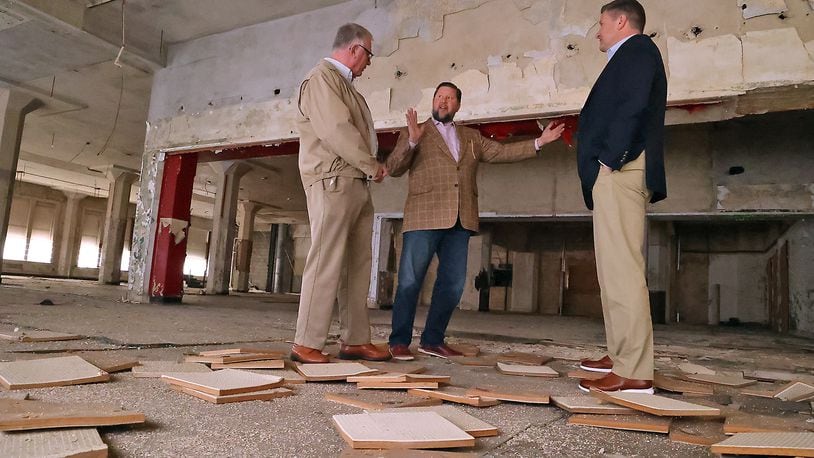 Ted Vander Roest, executive director of the Springfield Foundation, talks with John Landess and Daren Cotter, from the Turner Foundation, about the apartments that will be located in the upper floors of the Wren Building in downtown Springfield Wednesday. BILL LACKEY/STAFF