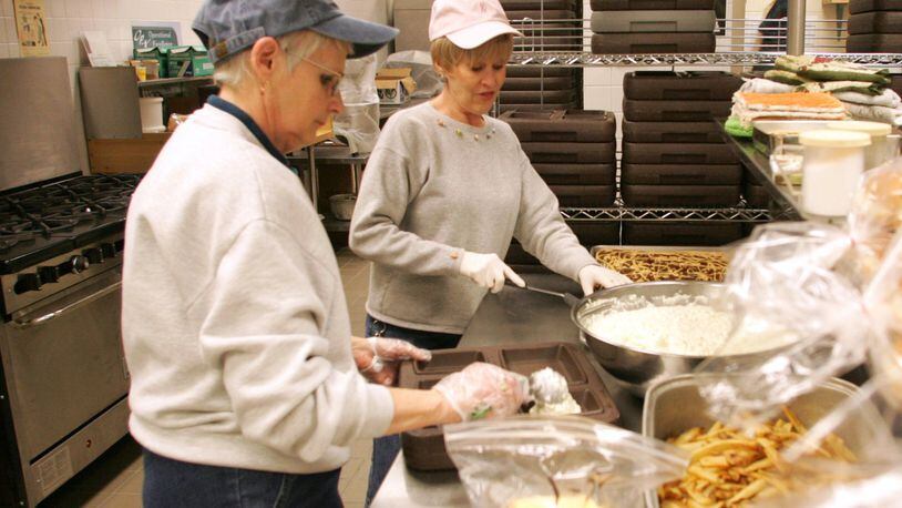 Aramark employees Linda Scheiding (left) and Joann Norvell work in the kitchen of the Preble County Jail in 2007. Ron Alvey/STAFF