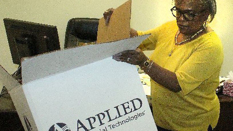 Denise Williams, President of Springfield Unit NAACP unpacks office supplies at the organization’s new office in downtown Springfield. JEFF GUERINI/STAFF