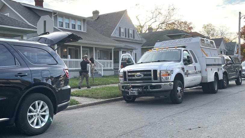 A Springfield Police Division evidence collection unit is shown at the scene of a house in the 200 block of W. Liberty Street. Law enforcement officials were seen Tuesday evening removing boxes of potential evidence, including a computer hard drive. | BILL LACKEY/STAFF