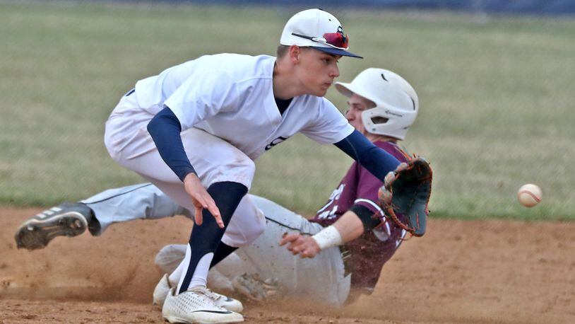 Lebanon’s Matthew Belongia slides safely into second as Springfield shortstop Triston Duncan waits for the throw from home. BILL LACKEY/STAFF