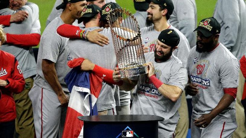 The Nationals' Adam Eaton holds the Commissioners Trophy after defeating the Houston Astros 6-2 in Game Seven to win the 2019 World Series in Game Seven of the 2019 World Series at Minute Maid Park on October 30, 2019 in Houston, Texas. (Photo by Bob Levey/Getty Images)