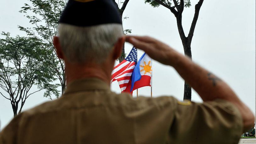 A retired American soldier salutes to the colors during Veterans Day JAY DIRECTO/AFP/Getty Images)