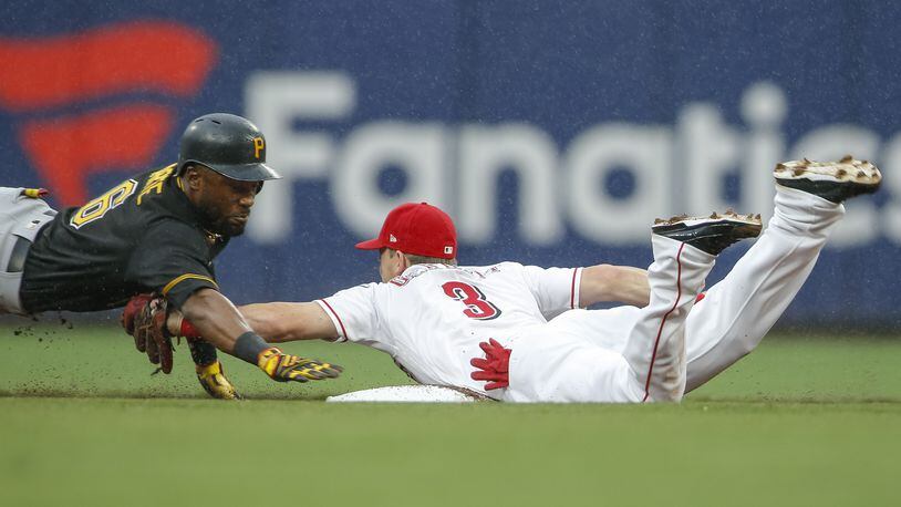 CINCINNATI, OH - JULY 21: Starling Marte #6 of the Pittsburgh Pirates reaches back for the bag as Scooter Gennett #3 of the Cincinnati Reds tags him out during the first inning at Great American Ball Park on July 21, 2018 in Cincinnati, Ohio. (Photo by Michael Hickey/Getty Images)