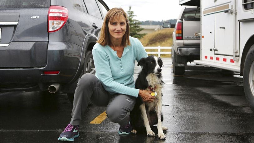In this photo taken Tuesday, Sept. 17, 2019, is Carole King of Deer Park, Washington, holding her border collie, Katie, who went missing for 57 days before she was located in a Kalispell, Montana neighborhood.