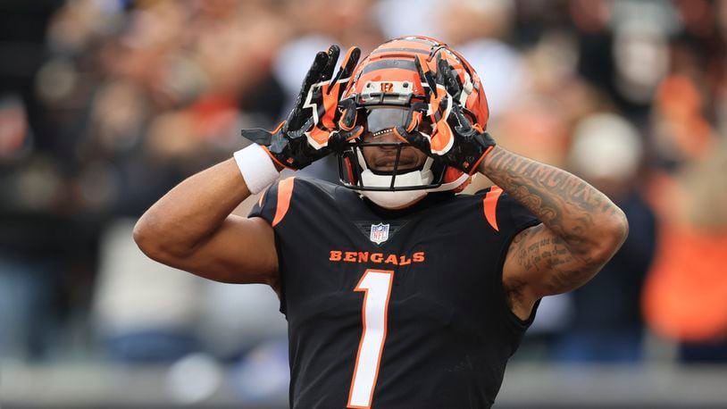 Cincinnati Bengals' Ja'Marr Chase celebrates after a touchdown catch during the first half of an NFL football game against the Cleveland Browns, Sunday, Dec. 11, 2022, in Cincinnati. (AP Photo/Aaron Doster)