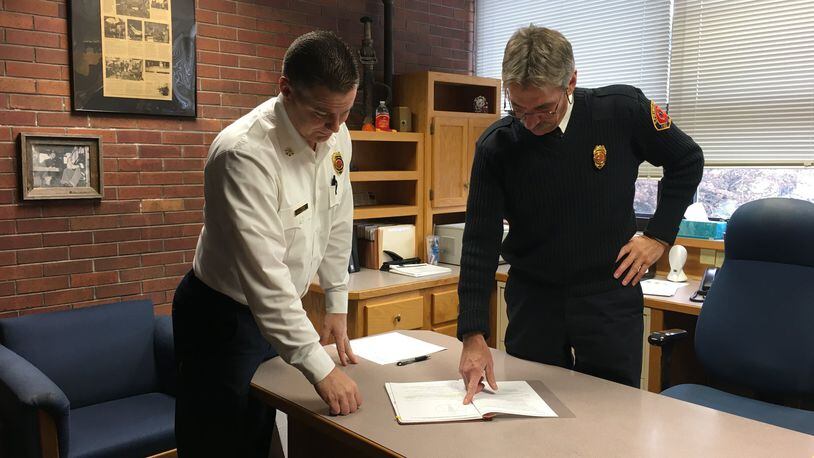 Soon to be Springfield Fire Chief Brian Miller and soon to retired Springfield Fire Chief Nick Heimlich look over plans for the division.
