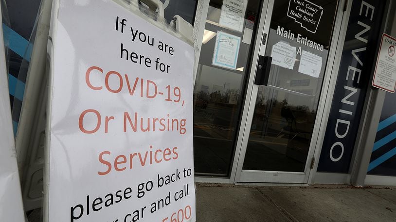 A sign outside the Clark County Combined Health District tells visitors to return to their car and call if they are at the office for COVID-19 or Nursing Services Tuesday. Clark County is expected to receive 1,800 doses of vaccine next week to be used for Phase 1b eligible residents, according to a statement from the county’s health department and EMA. BILL LACKEY/STAFF