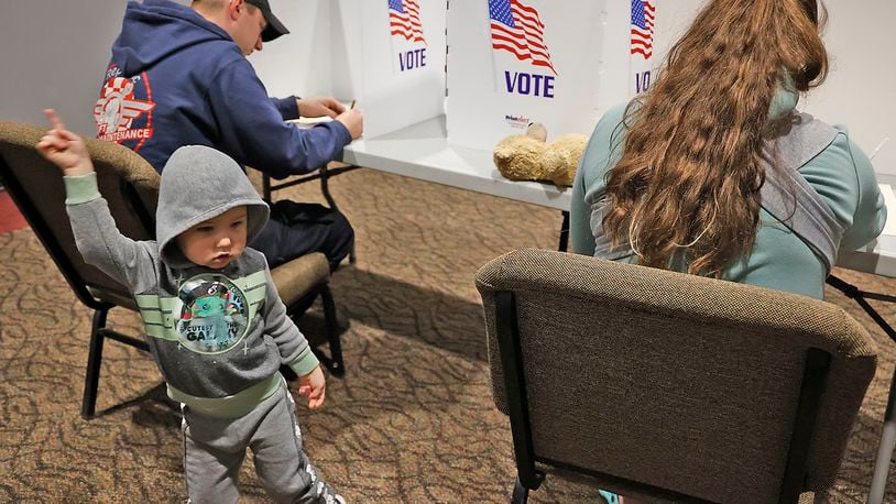Two-year-old Mathew McLain dances around as his parents cast their vote Tuesday, Nov. 8, 2022, at the First Christian Church in Moorefield Township in Clark County. BILL LACKEY/STAFF