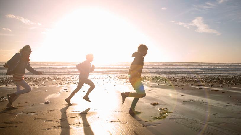 Children running on beach (stock photo)