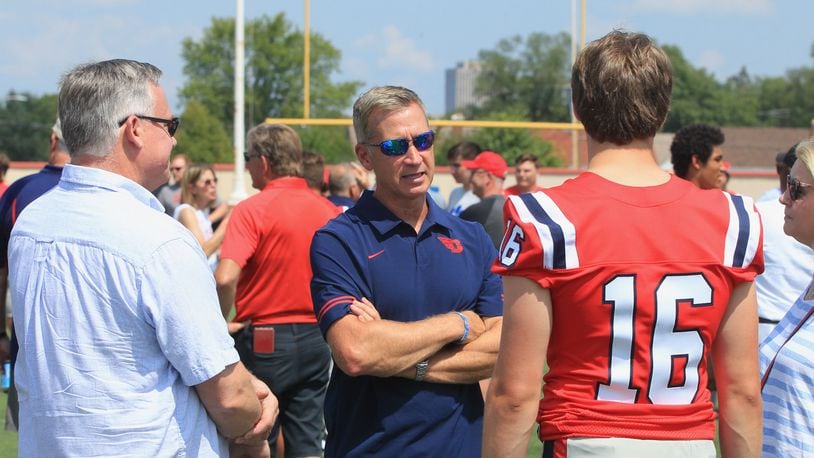 Offensive coordinator Jim Collins talks to the family of quarterback Spencer Hawkins at Dayton Flyers football photo day at Welcome Stadium on Sunday, Aug. 22, 2021. David Jablonski/Staff