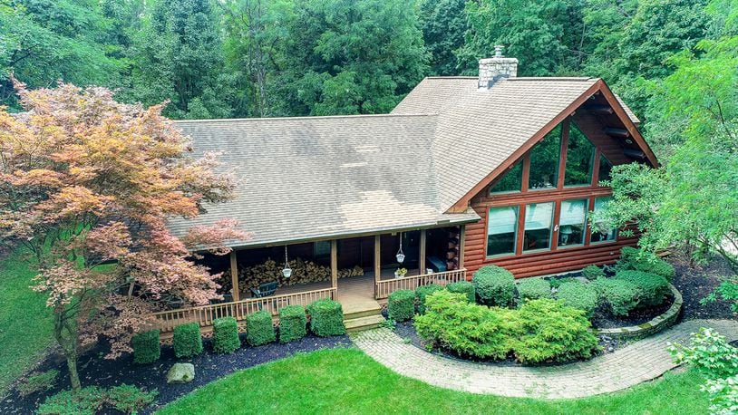 The 3-bedroom, log home with about 2,740 sq. ft. of living space, has a matching detached, 2-car log garage. The home includes a 4-season room, partially finished basement and loft. CONTRIBUTED PHOTO