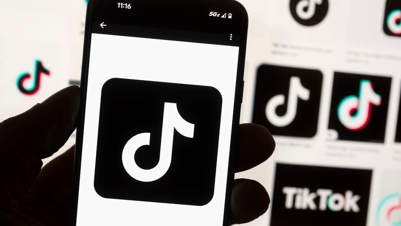 FILE - The TikTok logo is displayed on a mobile phone in front of a computer screen, Oct. 14, 2022, in Boston. Russian state-affiliated accounts have boosted their use of TikTok and are getting more engagement on the short-form video platform ahead of the U.S. presidential election, according to a new study released Thursday, May 2, 2024, by the nonprofit Brookings Institution. (AP Photo/Michael Dwyer, File)