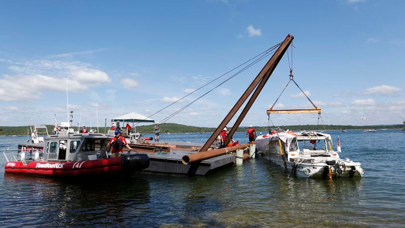 The duck boat that sank in Table Rock Lake in Branson, Missouri, is raised Monday, July 23, 2018. The boat went down after a thunderstorm generated near-hurricane strength winds.