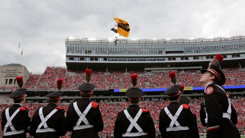 The U.S. Army Golden Knights parachute team flies into Ohio Stadium prior to a game against Ohio State at Ohio Stadium in Columbus, Ohio, on Saturday, Sept. 16, 2017. Ohio State won, 38-7. (Adam Cairns/Columbus Dispatch/TNS)
