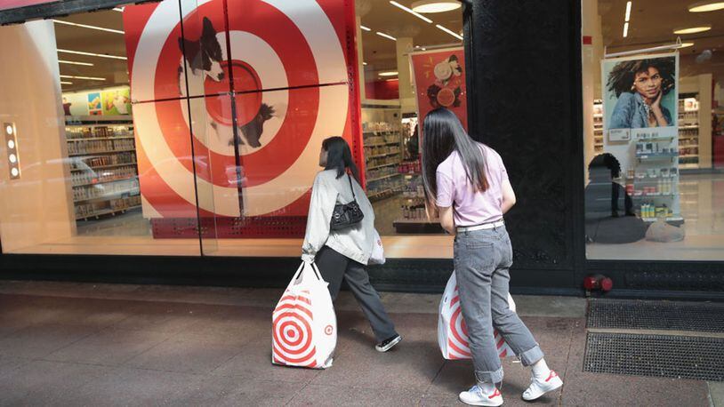 Shoppers carry away their purchases from a Target store.