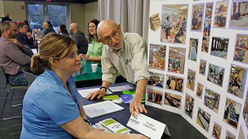 Grover Butler, from St. John's Lutheran Church, talks to Jodi Lucas, from Leadership Clark County, about some of the services they offer Thursday, April 11, 2024 during the Leadership Clark County Non-Profit Fair at the Hollenbeck Bayley Conference Center. BILL LACKEY/STAFF