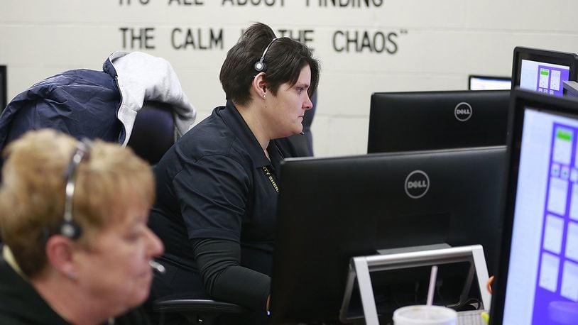 Rebecca French, center, and Myla Repik, dispatchers at the Clark County Sheriff’s office answer calls Thursday. Eight of the 10 townships are expected to use the Sheriff’s Office for dispatching. Bill Lackey/Staff