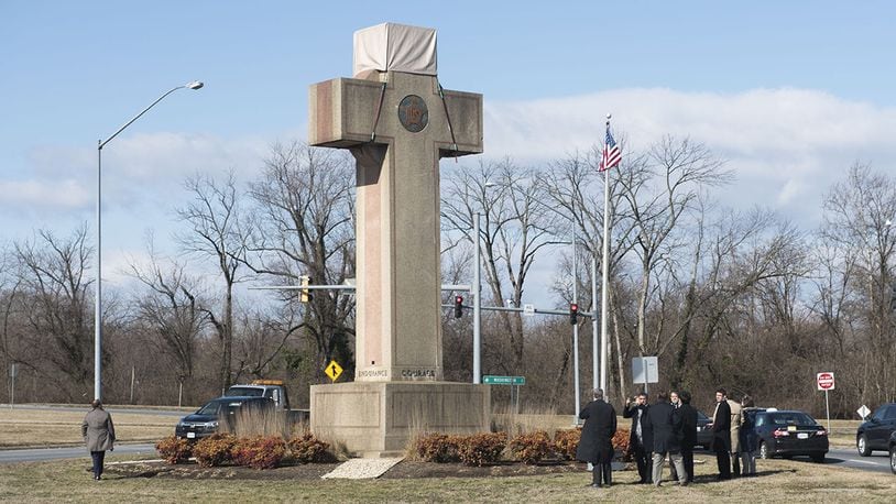 In this Feb. 13, 2019 file photo, visitors walk around the 40-foot Maryland Peace Cross dedicated to World War I soldiers in Bladensburg, Maryland.