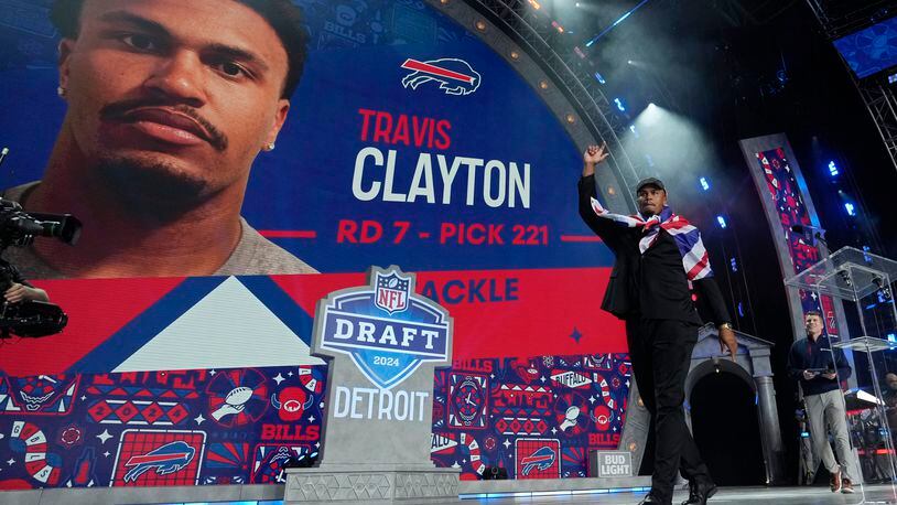 Travis Clayton reacts after being picked by the Buffalo Bills with the 221st overall pick in the seventh round during the third day of the NFL football draft, Saturday, April 27, 2024, in Detroit. (AP Photo/Jeff Roberson)