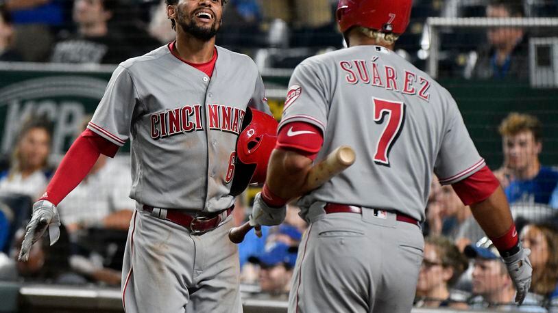 KANSAS CITY, MO - JUNE 12: Billy Hamilton #6 of the Cincinnati Reds celebrates with Eugenio Suarez #7 after scoring on a Joey Votto three-run triple in the 10th inning against the Kansas City Royals at Kauffman Stadium on June 12, 2018 in Kansas City, Missouri. (Photo by Ed Zurga/Getty Images)
